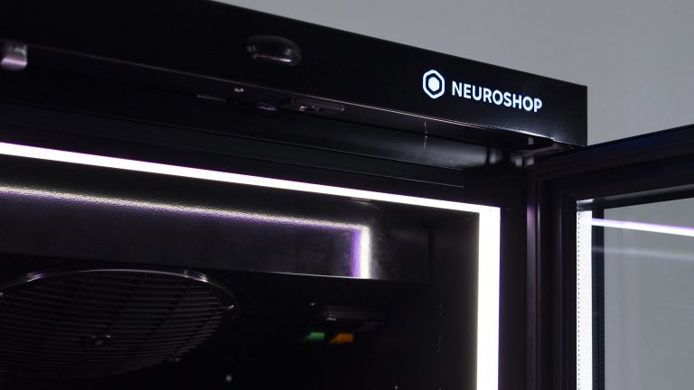 Top panel of a cabinet with a lit Neuroshop logo and an LED strip along the door edge