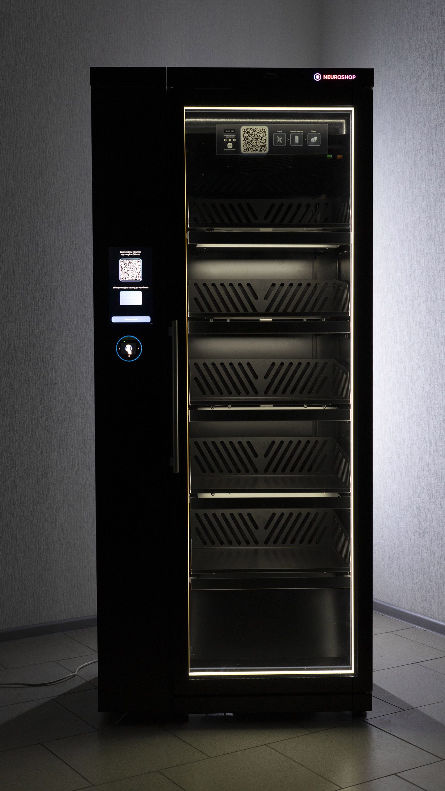 Black cabinet with a glass door and empty shelves, a screen with a QR code on the front panel